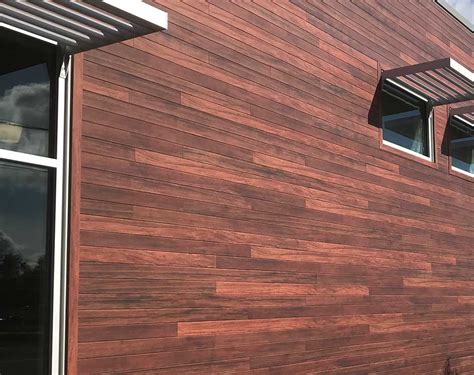 veranda faux wood or metal front of hte house|painted siding that looks like wood.